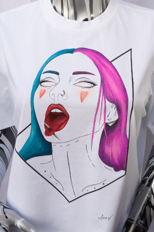 A white t-shirt with a graphic design on a plain background. The design is hand painted and shows a girl with half hair blue half pink, 2 red hearts on the cheeks and a needle through her tongue.