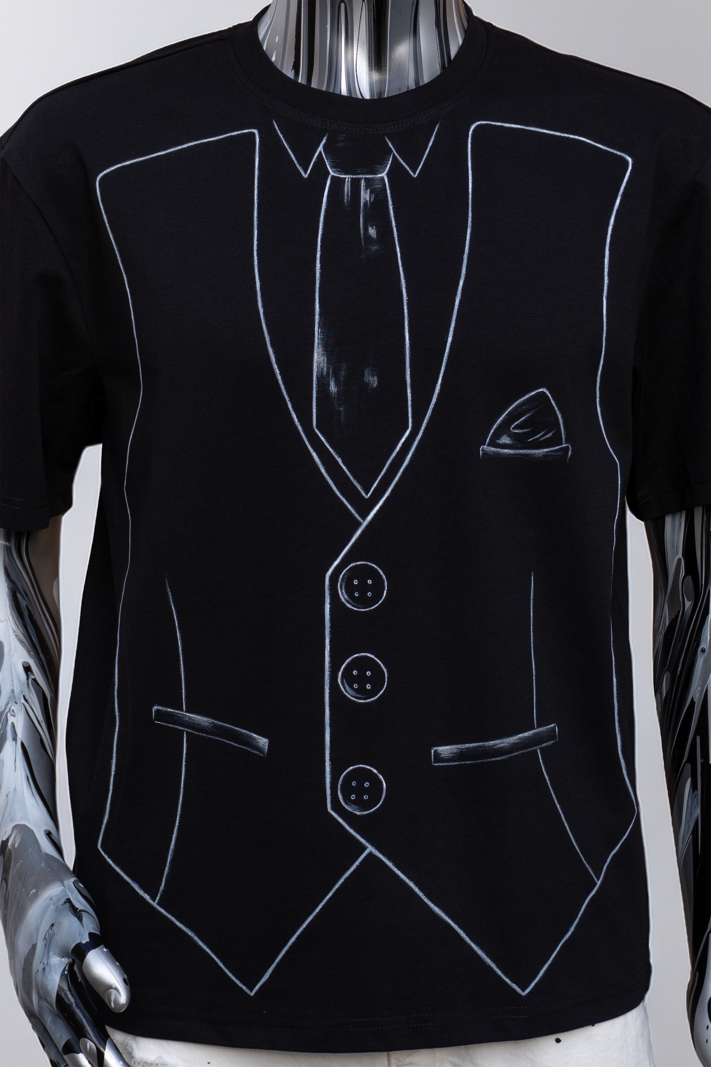 Close up of a Black t-shirt with white outline of a suit and tie on a male mannequin.