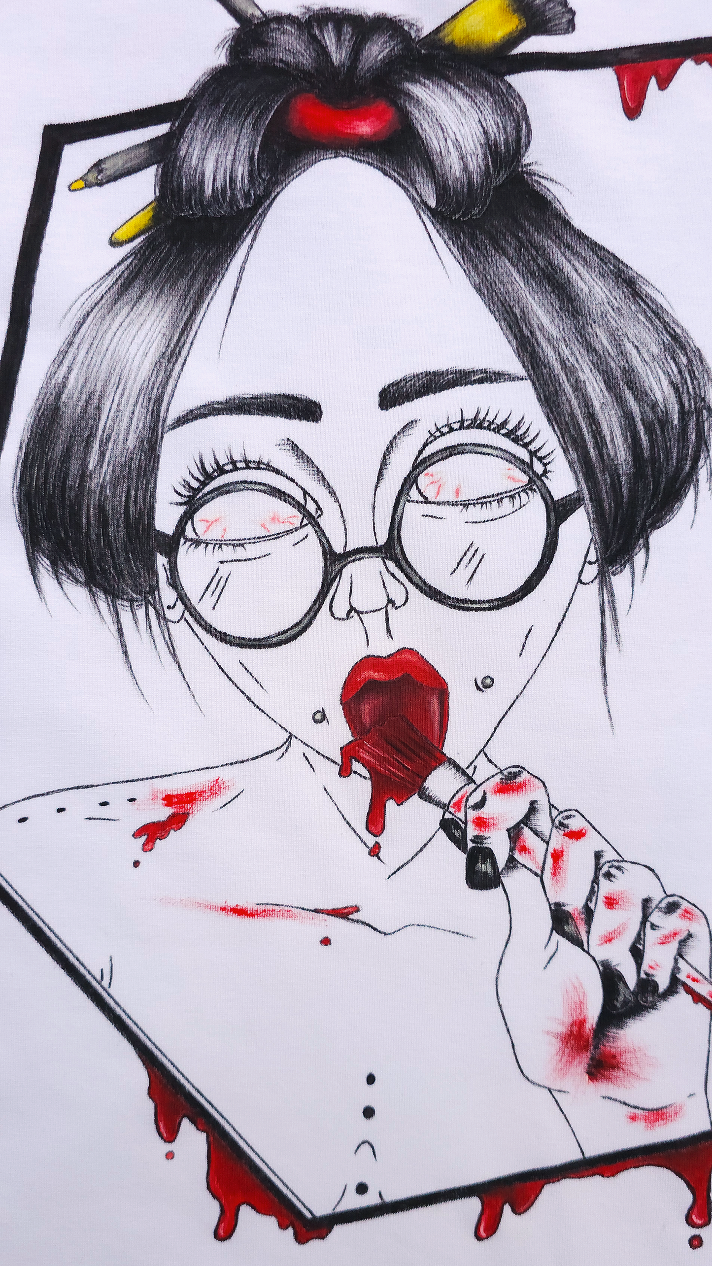 White t-shirt with a graphic design. The design is hand painted and shows a girl with round glasses, red paint dripping and a brush. This is a close up.