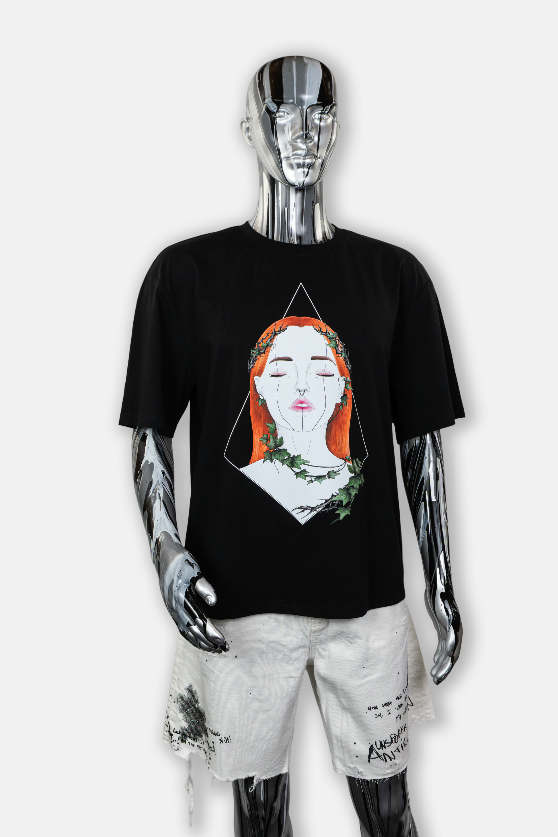 Male mannequin wearing Tangled Ivy men's black tee with hand-drawn nature-inspired ivy patterns