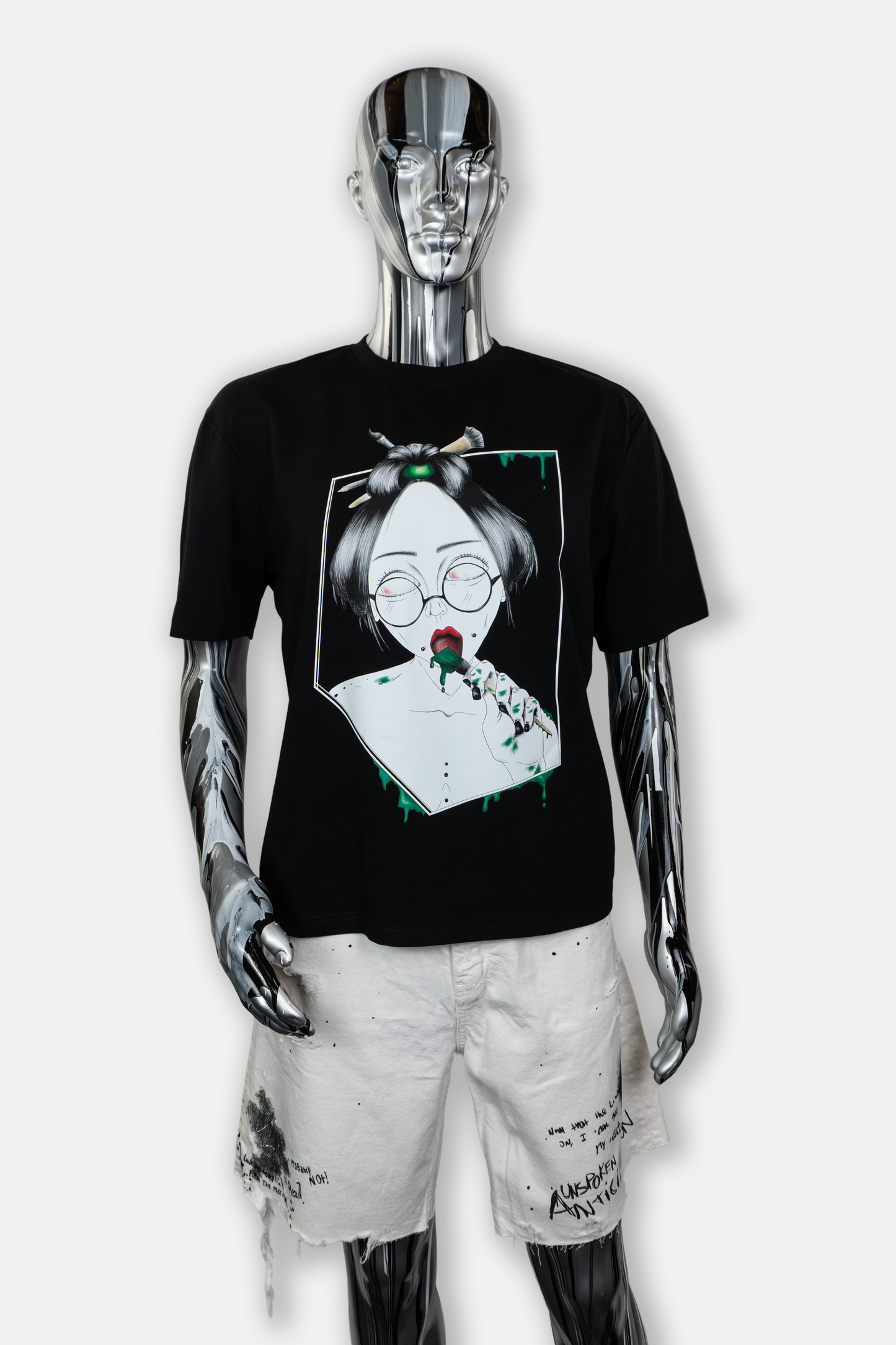 Male mannequin wearing Painted in Green men's black t-shirt with bold green hand-drawn brushstrokes