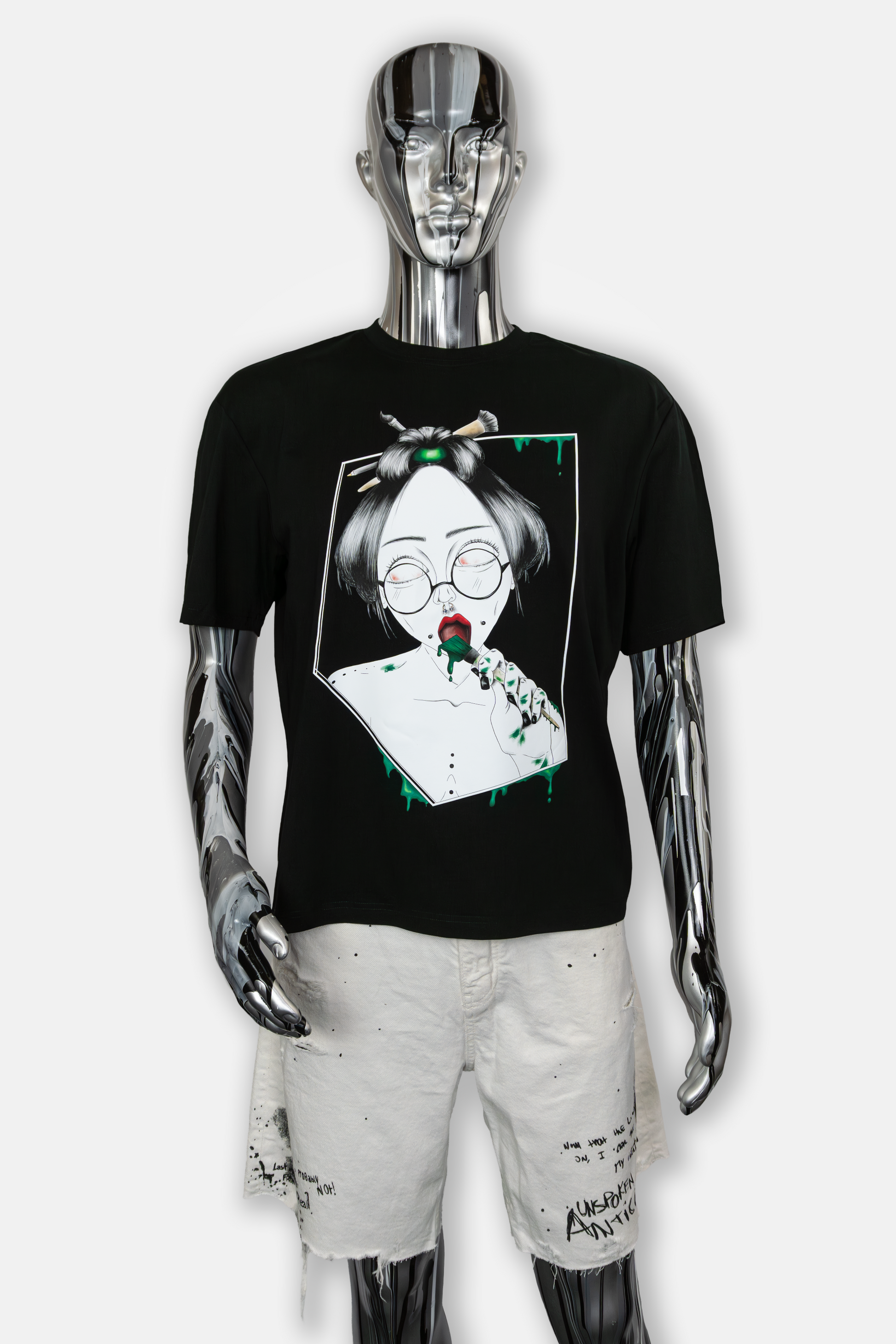 Male mannequin wearing Painted in Green Pierced Edition on black T-shirt