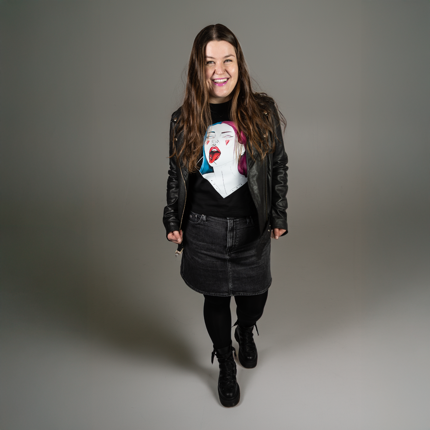 Woman wearing a black leather jacket with a graphic design black tshirt