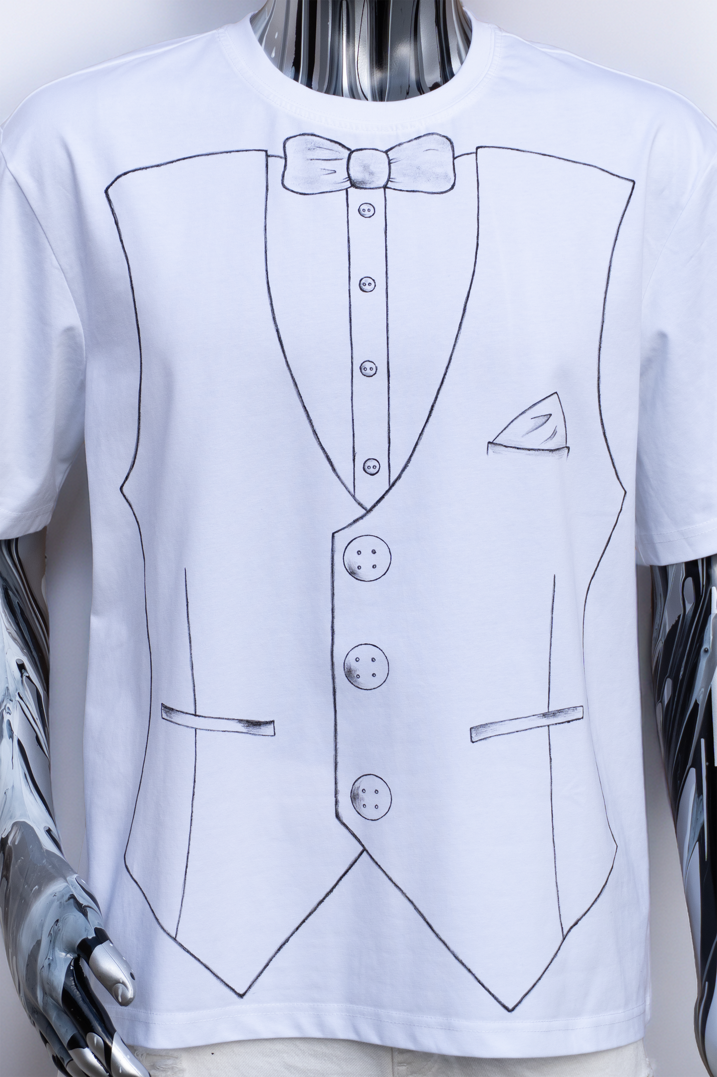 Close up of a White t-shirt with black outline of a suit and bow on a male mannequin.