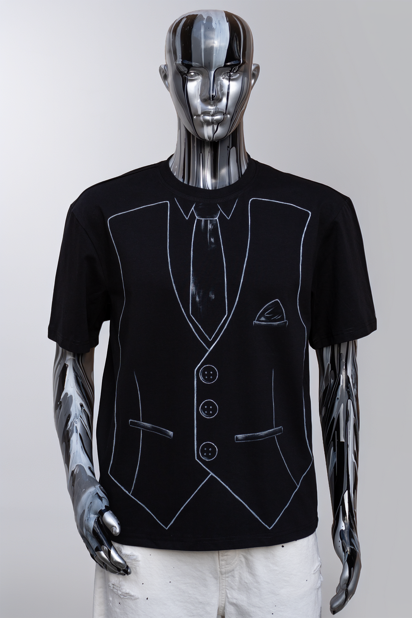 Black t-shirt with white outline of a suit and tie on a male mannequin against a gray background