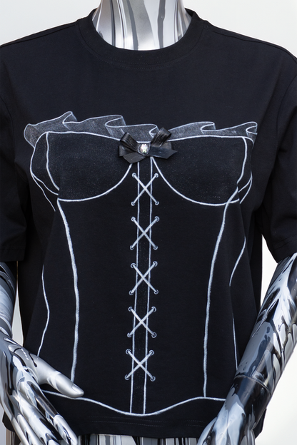 Close up of female mannequin wearing a black t-shirt with white lace-up corset hand painted on the tshirt, with a hand sewed bow